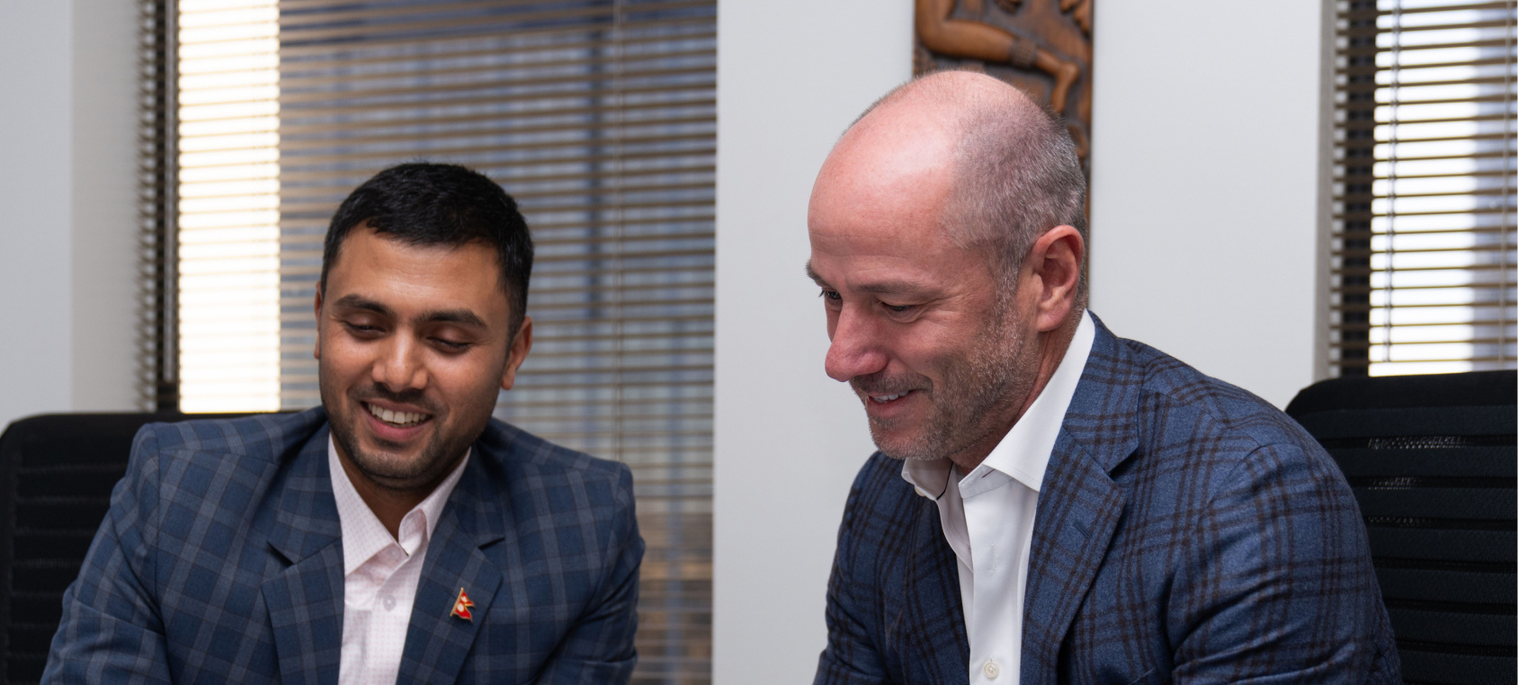 FlexTecs leadership team members from Nepal and the U.S. collaborating in an office setting.