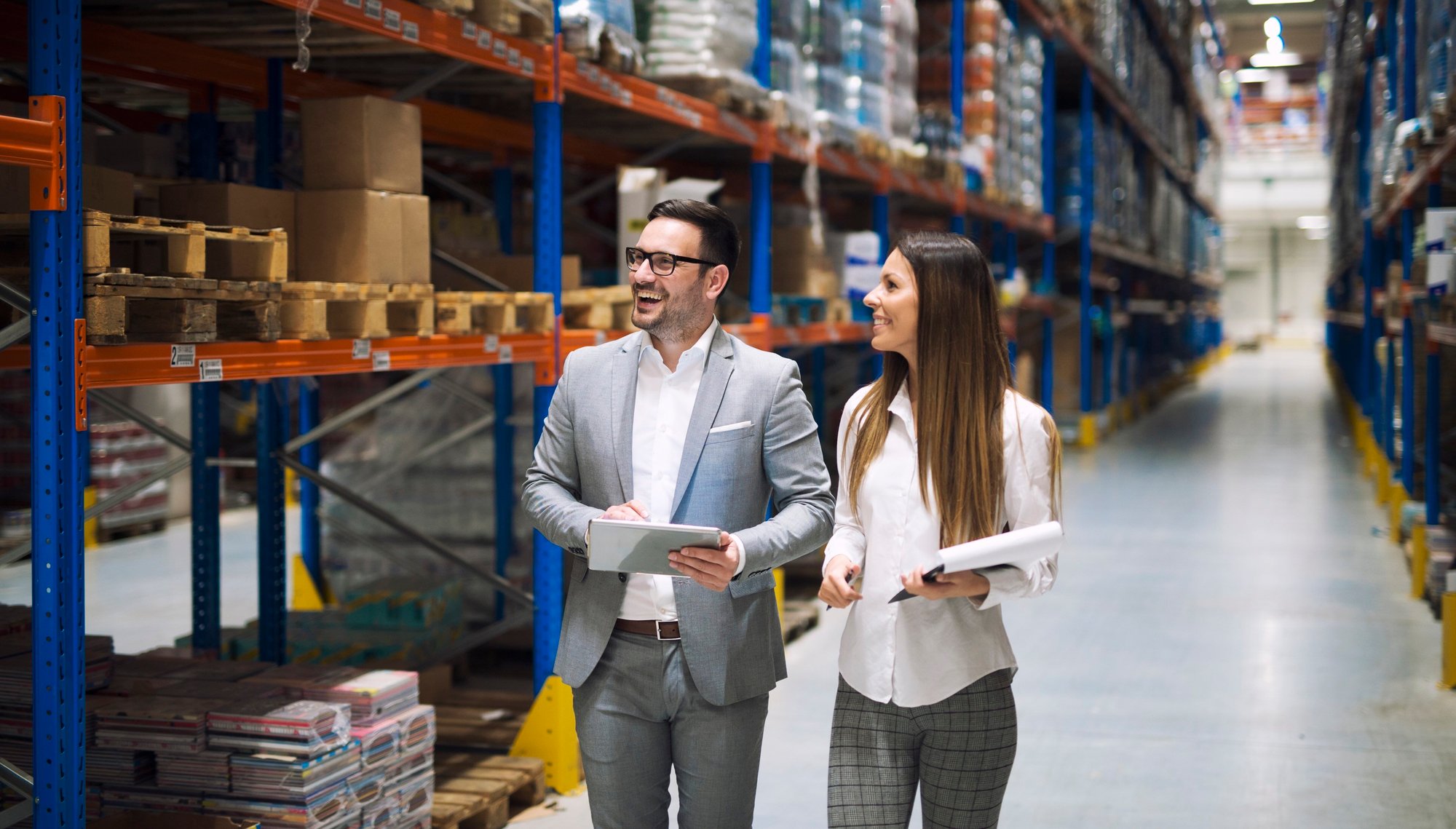 Finance team conducts supplier inventory analysis while walking in the warehouse.