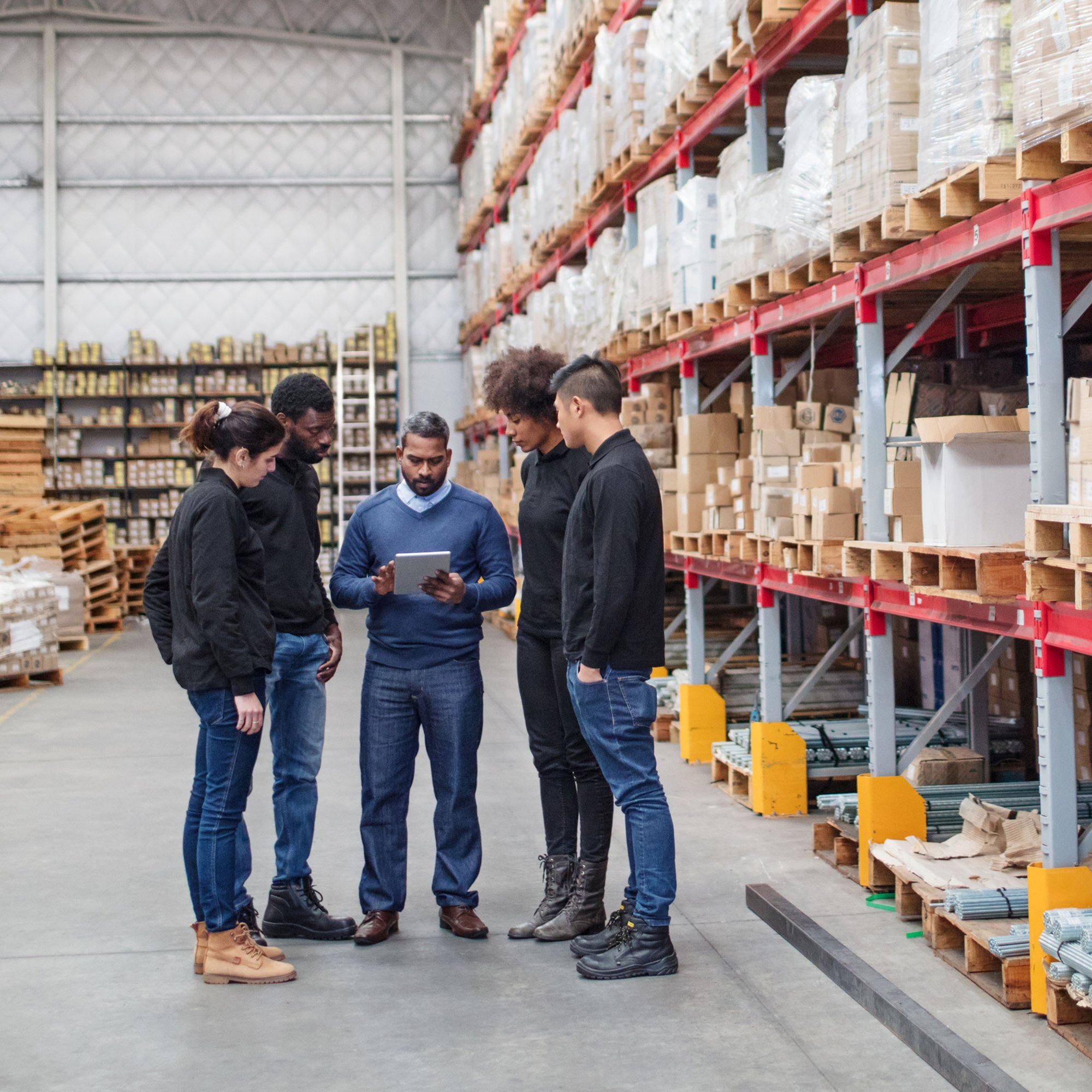 AP team reviewing accounts payable prepayment records in warehouse to prevent overpayments.